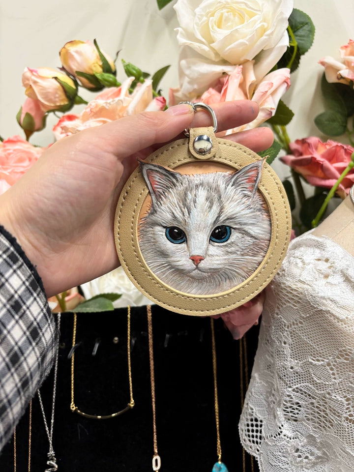 White and grey cat portrait on almond leather keychain with floral background
